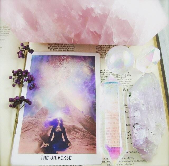 Tarot with pink quartz crystals and dried purple flower